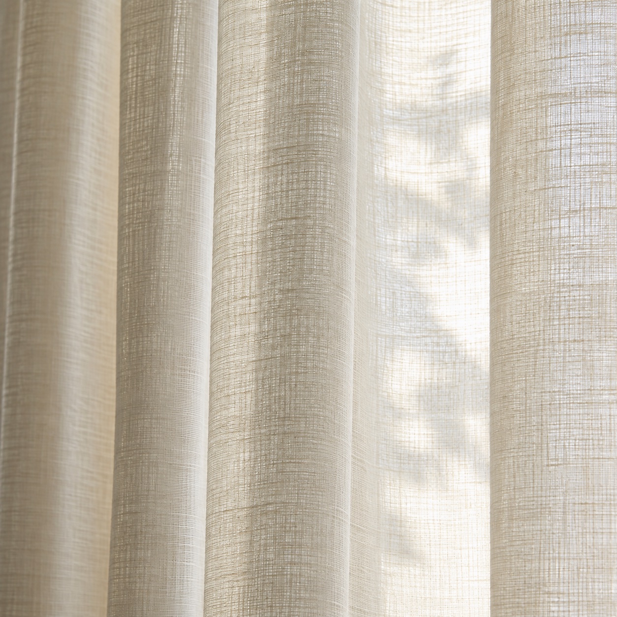 Linen-blend sheer drapery softly filtering daylight in a hospitality interior